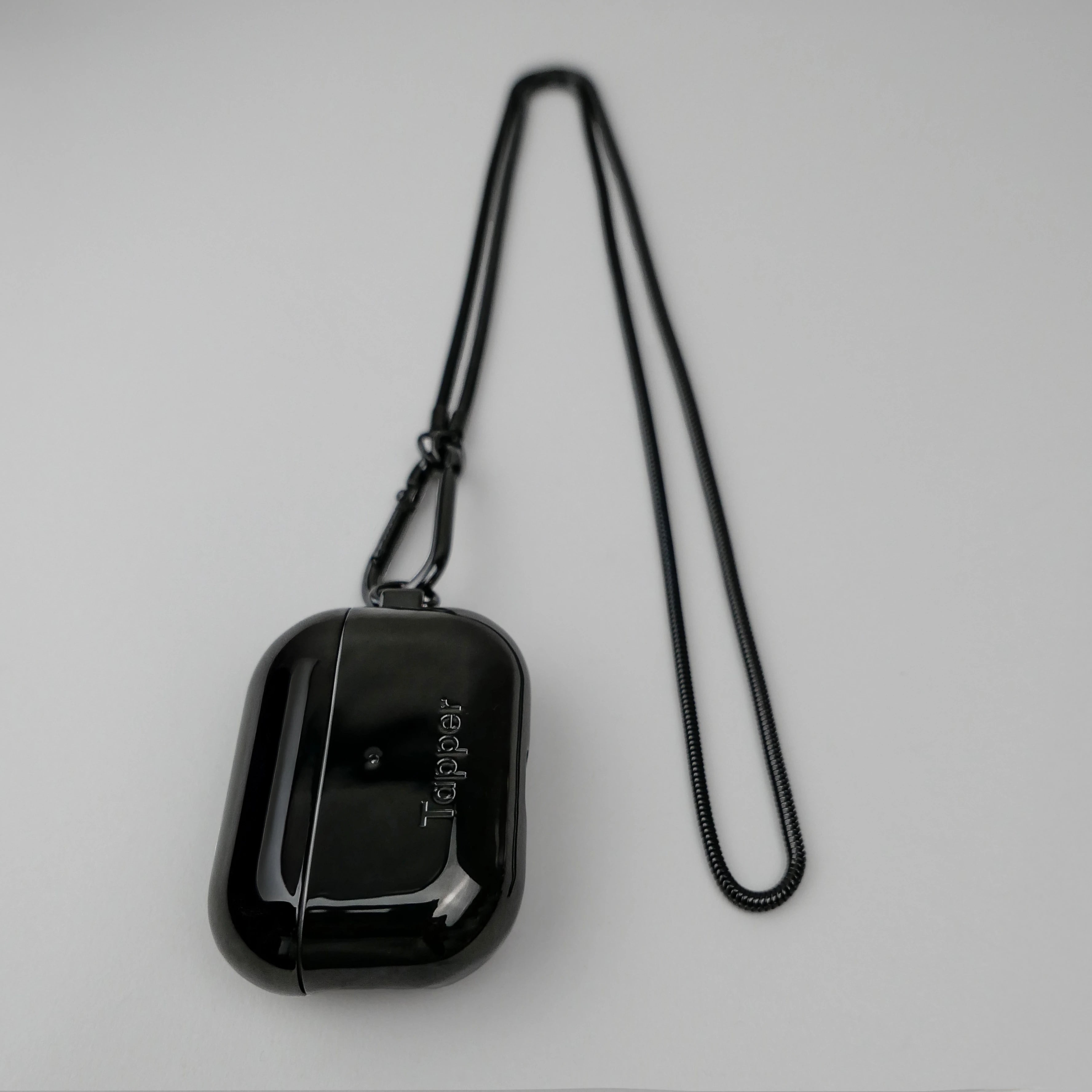 Tapper's real hematite black plated original metal neck case tech jewelry protects and keeps your Apple AirPods Pro close at hand. The luxurious, elevated and accessible neck case plated in precious metals steps up your AirPods Pro jewellery game. Worried about losing your AirPods? Detachable snake chain and carabiner for convenient and hassle-free safekeeping around your neck. The next must-have accessory crafted for ultimate luxury. Compatible with AirPods Pro. Designed in Sweden. Free Express Shipping.