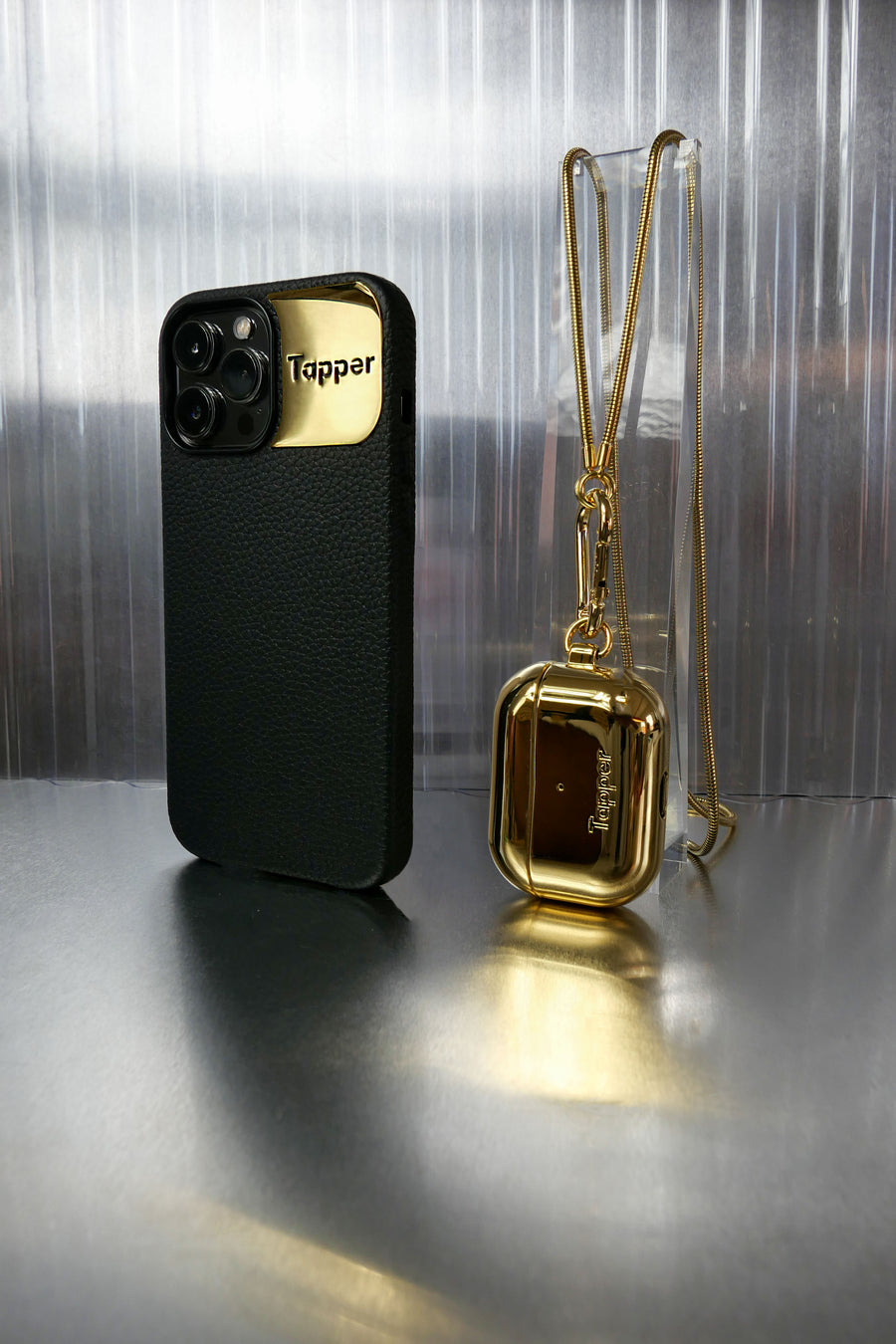Tapper's real 18K gold plated original metal neck case tech jewelry protects your Apple AirPods Pro. The luxurious, elevated and accessible neck case plated in precious metals steps up your AirPods Pro jewellery game. Worried about losing your AirPods? Detachable snake chain and carabiner for convenient and hassle-free safekeeping around your neck. The next must-have accessory crafted for ultimate luxury. Compatible with AirPods Pro. Designed in Sweden by Tapper. Free Express Shipping at gettapper.com