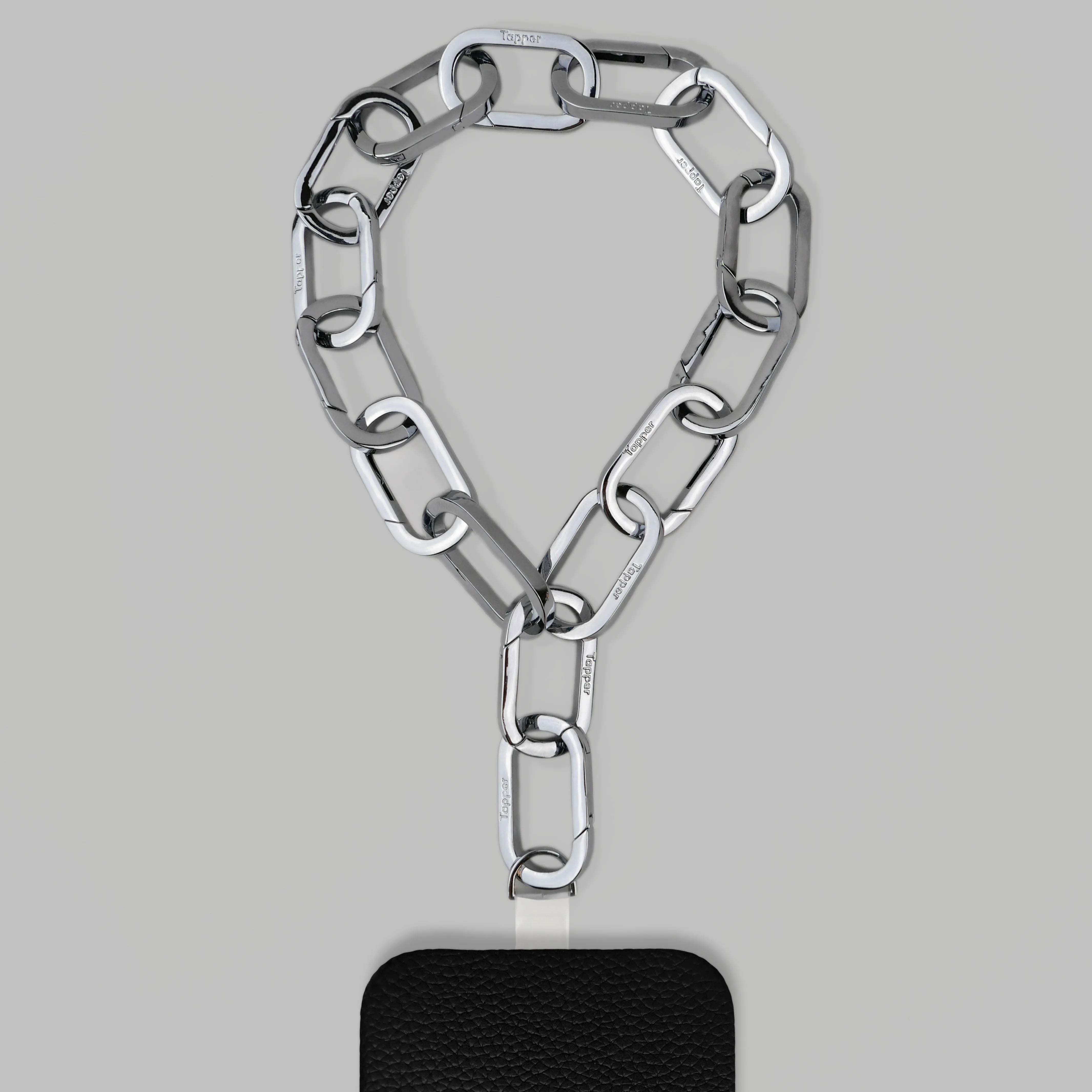 Tapper's Adjustable Phone Carabiner Wristlet Strap is an elevated metal phone wrist chain colored in Silver, designed to complement your phone case and your jewellery. Combine style with function by securing your phone to your wrist, belt loop or bag, protecting it from drops and falls as well as keeping it safe from pickpocketing. When not in use as a phone chain, adjust the carabiner links and use it as a bracelet or necklace instead. Compatible with all phone cases (iPhone, Samsung, Xiaomi, Oppo,Vivo