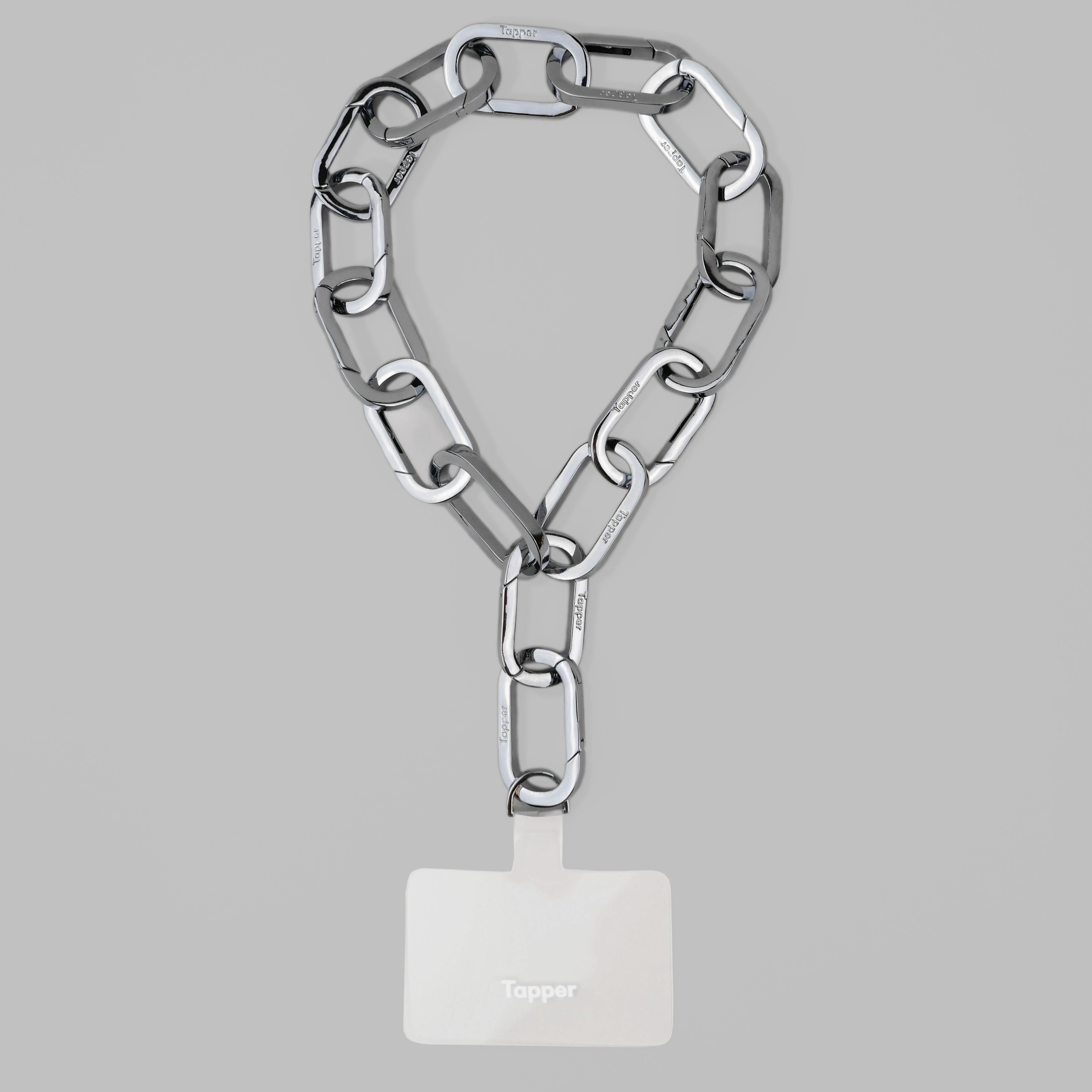 Tapper's Adjustable Phone Carabiner Wristlet Strap is an elevated metal phone wrist chain colored in Silver, designed to complement your phone case and your jewellery. Combine style with function by securing your phone to your wrist, belt loop or bag, protecting it from drops and falls as well as keeping it safe from pickpocketing. When not in use as a phone chain, adjust the carabiner links and use it as a bracelet or necklace instead. Compatible with all phone cases (iPhone, Samsung, Xiaomi, Oppo,Vivo