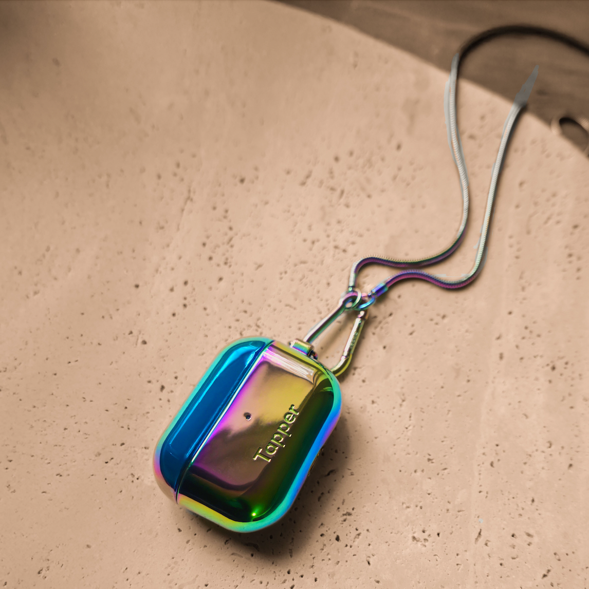 Tapper's Oil Gradient plated original metal neck case jewelry protects your Apple AirPods Pro. Luxurious, elevated & accessible AirPods Pro jewellery plated in precious metals. Worried about losing your AirPods Pro? Detachable snake chain and carabiner for convenient and hassle-free safekeeping around your neck. The next must-have AirPods Pro accessory crafted for ultimate luxury. Compatible with AirPods Pro. Designed in Sweden by Tapper. Free Express Shipping at gettapper.com