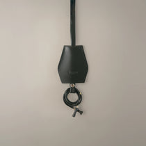 Handmade black leather AirPods strap and leather key holder with keychain and pouch ring, crafted in Sweden