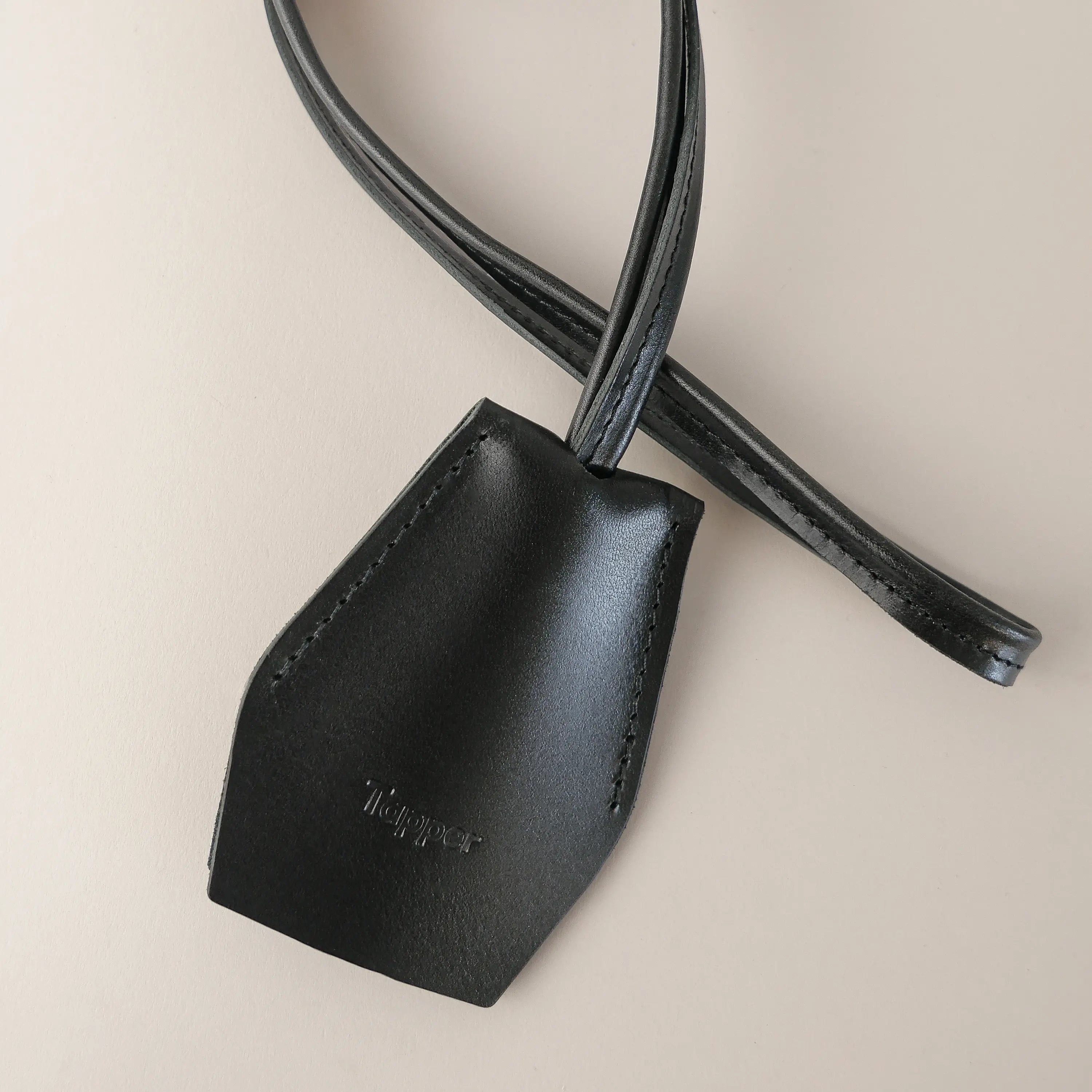Handmade black leather AirPods strap and leather key holder with keychain and pouch ring, crafted in Sweden