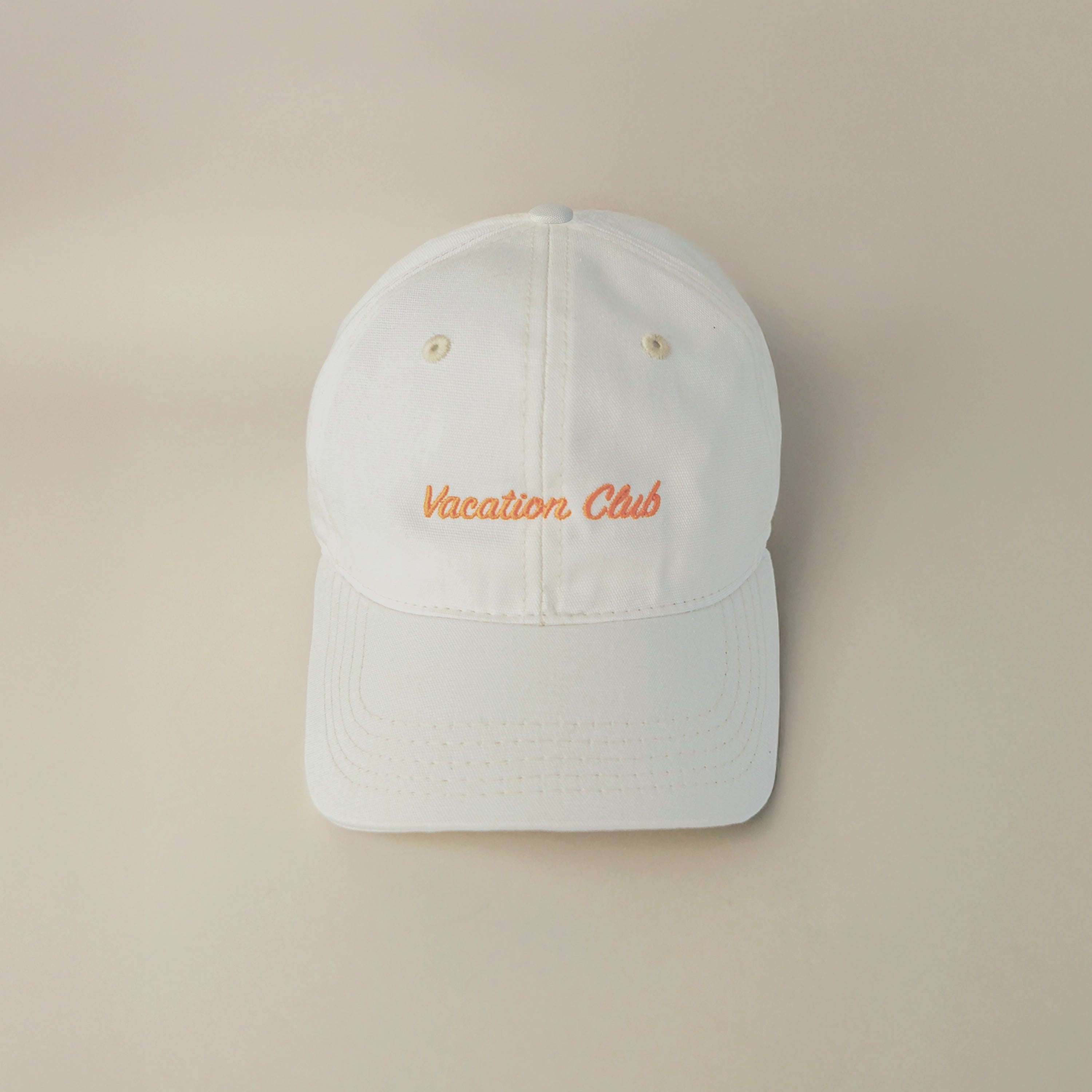 Tapper's Vacation Club cap in GOTS-certified organic cotton, featuring elegant embroidery — styled for summer with a chic, sunlit vibe, perfect for beach days, golden hours, and relaxed city strolls.