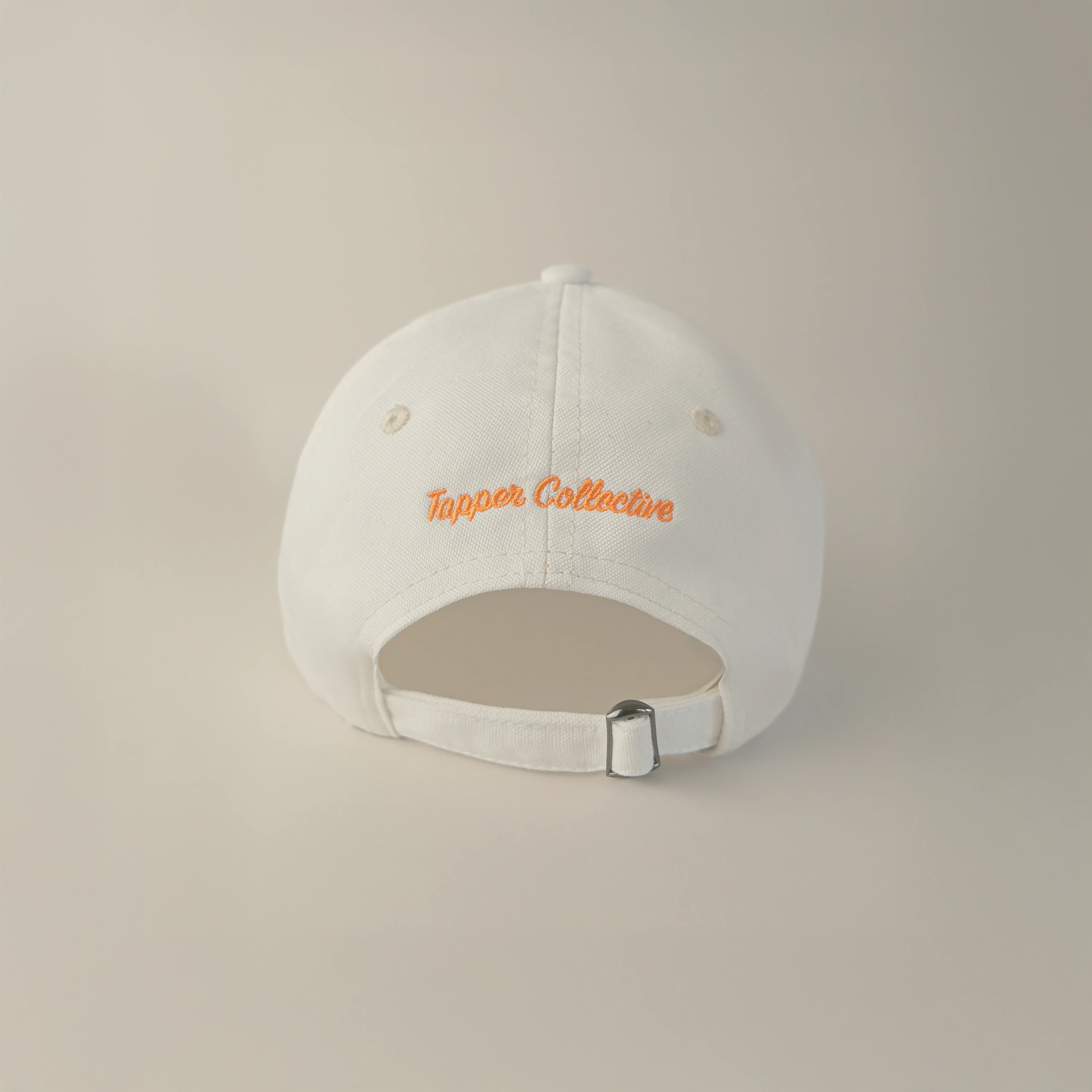 Tapper's Vacation Club cap in GOTS-certified organic cotton, featuring elegant embroidery — styled for summer with a chic, sunlit vibe, perfect for beach days, golden hours, and relaxed city strolls.