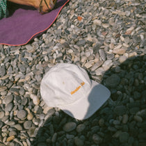 Tapper's Vacation Club cap in GOTS-certified organic cotton, featuring elegant embroidery — styled for summer with a chic, sunlit vibe, perfect for beach days, golden hours, and relaxed city strolls.