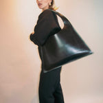 Minimalist leather tote bag handmade in Sweden, premium handbag designed for modern work and travel needs.