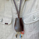 Handmade black leather AirPods strap and leather key holder with keychain and pouch ring, crafted in Sweden