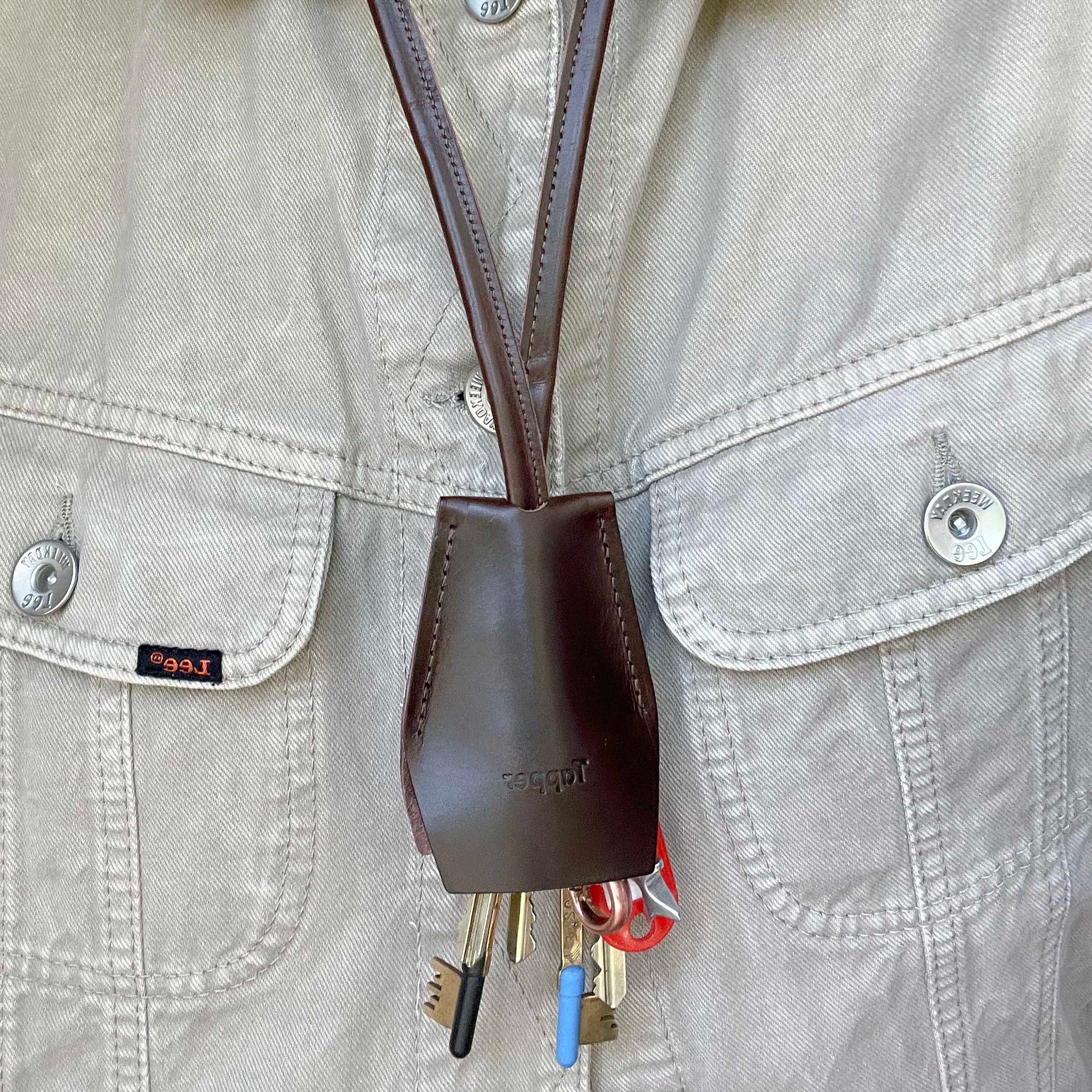 Handmade black leather AirPods strap and leather key holder with keychain and pouch ring, crafted in Sweden