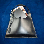 Minimalist leather tote bag handmade in Sweden, premium handbag designed for modern work and travel needs.