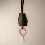 Handmade black leather AirPods strap and leather key holder with keychain and pouch ring, crafted in Sweden