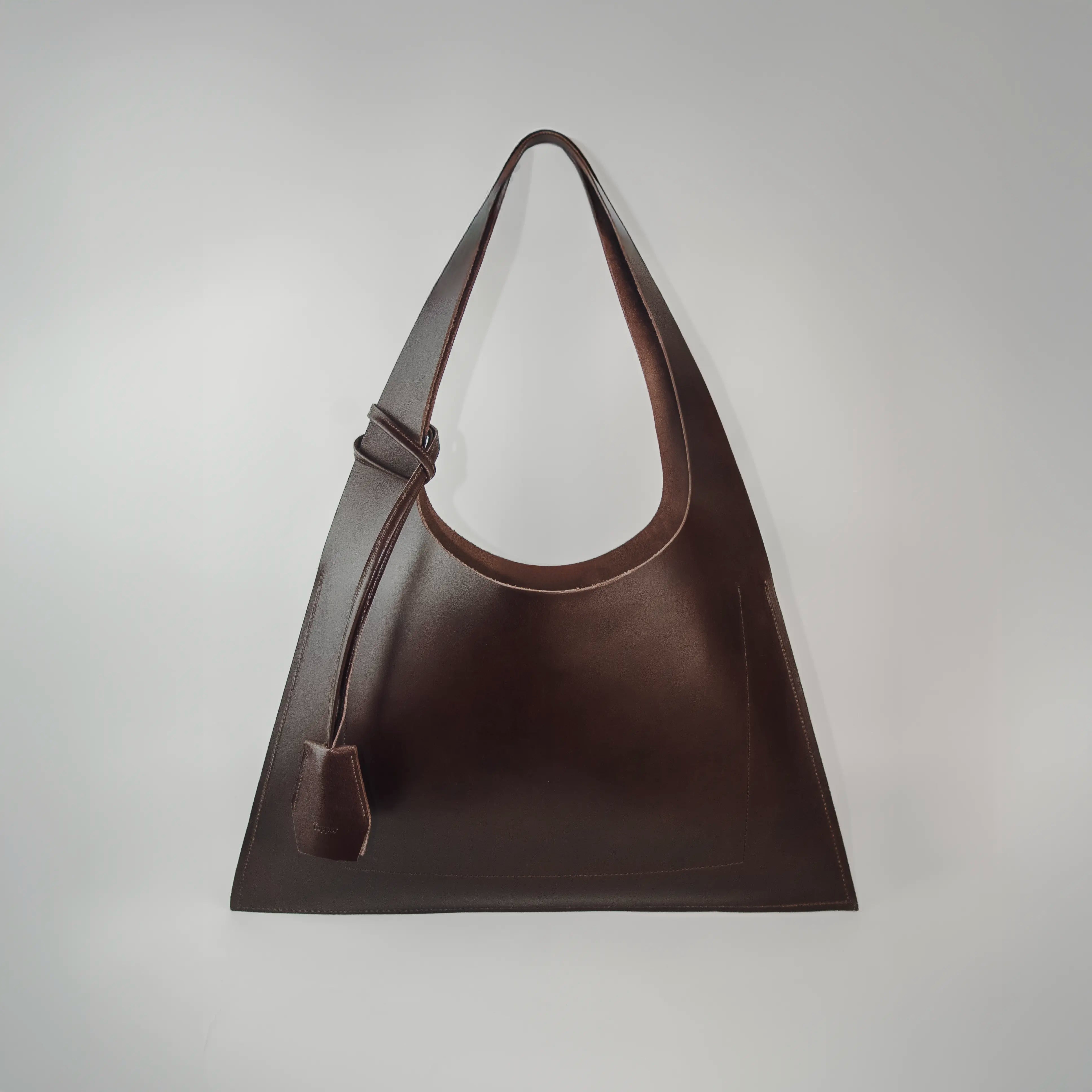 Large premium leather tote bag handmade in Sweden, a sculptural tote bag and handbag designed for work and travel, crafted from vegetable-tanned leather and sized to function as a leather laptop bag fitting up to a 16-inch laptop.