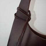 Leather tote bag for work and travel crafted from vegetable-tanned leather, structured handbag with clean sculptural form.