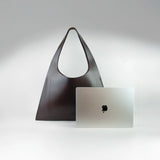 Large premium leather tote bag handmade in Sweden, a sculptural tote bag and handbag designed for work and travel, crafted from vegetable-tanned leather and sized to function as a leather laptop bag fitting up to a 16-inch laptop.