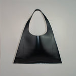 Minimalist leather tote bag handmade in Sweden, premium handbag designed for modern work and travel needs.