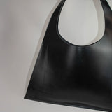 Minimalist leather tote bag handmade in Sweden, premium handbag designed for modern work and travel needs.