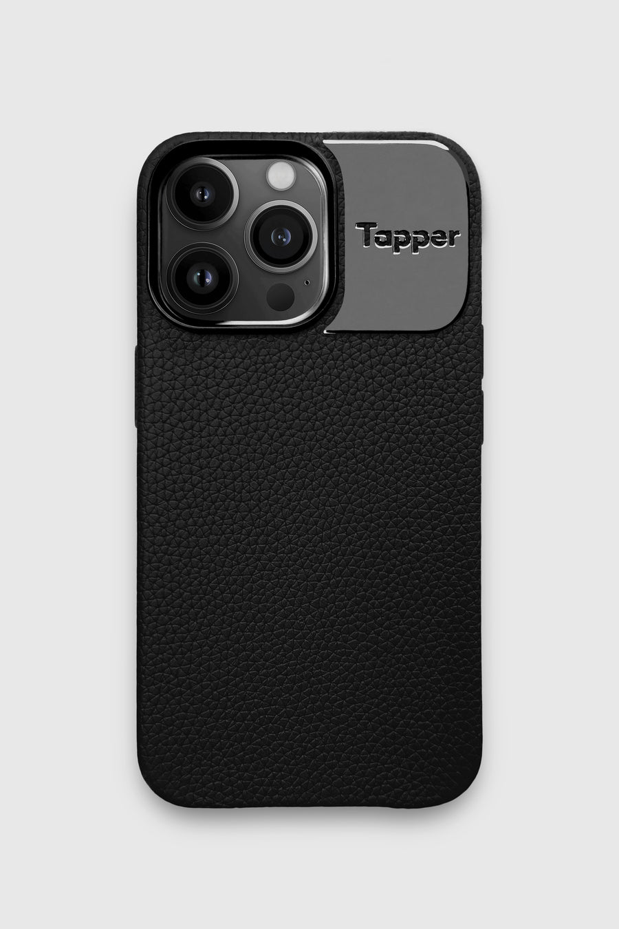 Tapper's luxurious black genuine cow leather iPhone 13 Pro case with MagSafe and a metal logo plate in hematite black plating that protects and elevates the look of your iPhone 13 Pro. The next must-have high end protective Apple iPhone accessory in real leather and precious metals. Designed in Sweden by Tapper. Free Express Shipping at gettapper.com