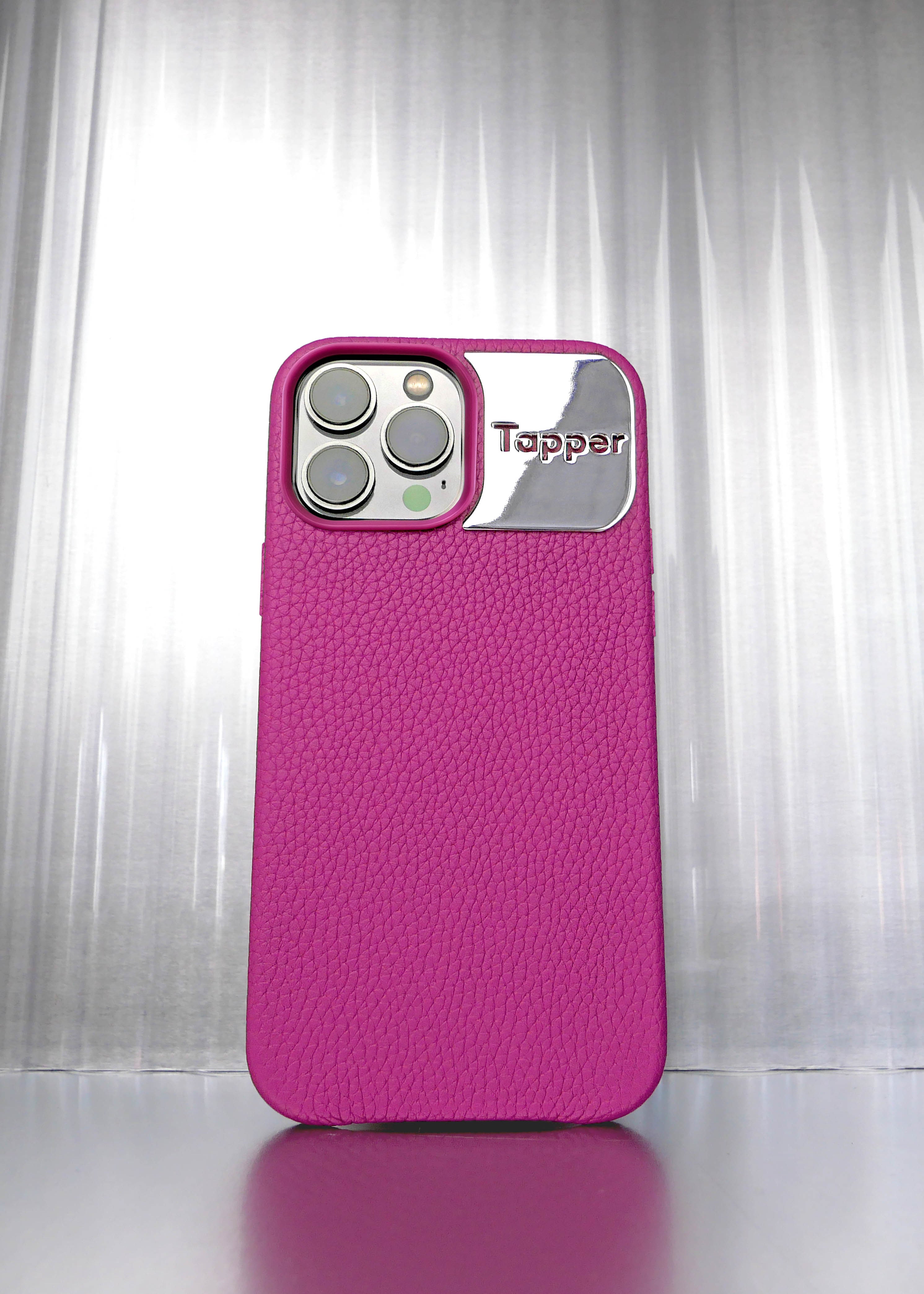 Tapper's luxurious limited edition all hot pink genuine cow leather iPhone 13 Pro Max case with MagSafe and a metal logo plate colored in silver that protects and elevates the look of your iPhone 13 Pro Max. The next must-have high end protective bright pink Apple iPhone accessory in real leather and metal details.  Designed in Sweden by Tapper. Free Express Shipping at gettapper.com