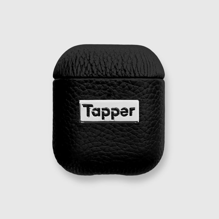 Tapper's luxurious black genuine lamb leather AirPods case protects and elevates the look of your AirPods. The luxurious, protective case for AirPods with a metal logo plate colored in silver steps up your AirPods game. The next must-have high end protective Apple AirPods accessory in real leather and metal details. Compatible with AirPods (1st and 2nd generation). Designed in Sweden by Tapper. Free Express Shipping at gettapper.com
