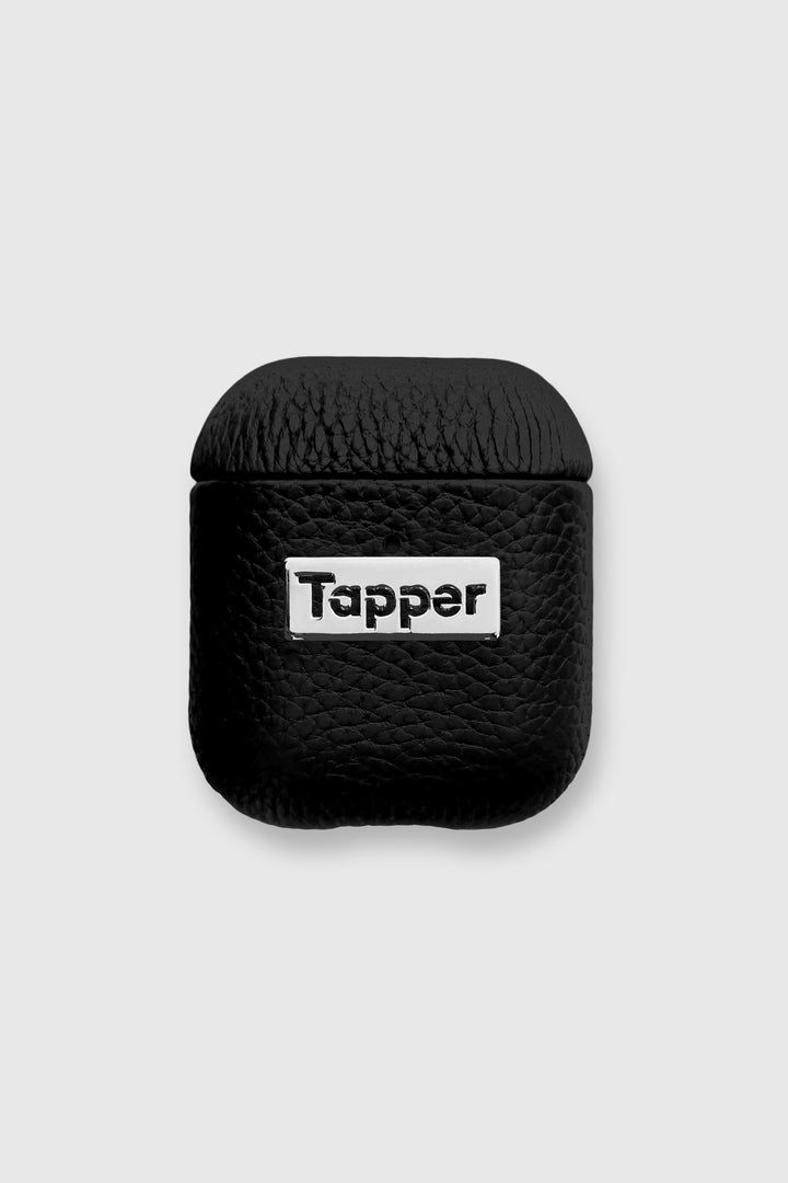 Tapper's luxurious black genuine lamb leather AirPods case protects and elevates the look of your AirPods. The luxurious, protective case for AirPods with a metal logo plate colored in silver steps up your AirPods game. The next must-have high end protective Apple AirPods accessory in real leather and metal details. Compatible with AirPods (1st and 2nd generation). Designed in Sweden by Tapper. Free Express Shipping at gettapper.com