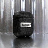 Tapper's luxurious black genuine cow leather AirPods case protects and elevates the look of your AirPods. The luxurious, protective case for AirPods with a metal logo plate colored in silver steps up your AirPods game. The next must-have high end protective Apple AirPods accessory in real leather and metal details. Compatible with AirPods (1st and 2nd generation). Designed in Sweden by Tapper. Free Express Shipping at gettapper.com