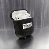 Tapper's luxurious black genuine cow leather AirPods case protects and elevates the look of your AirPods. The luxurious, protective case for AirPods with a metal logo plate colored in silver steps up your AirPods game. The next must-have high end protective Apple AirPods accessory in real leather and metal details. Compatible with AirPods (1st and 2nd generation). Designed in Sweden by Tapper. Free Express Shipping at gettapper.com