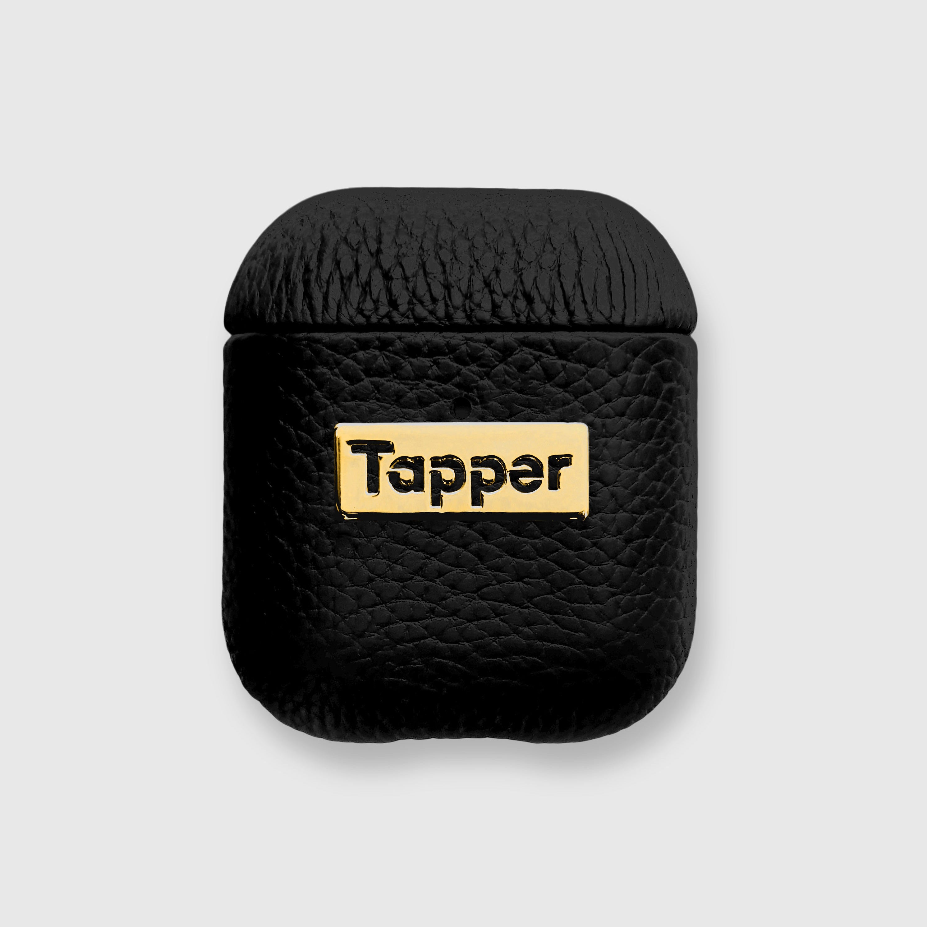 Tapper's luxurious black genuine lamb leather AirPods case protects and elevates the look of your AirPods. The luxurious, protective case for AirPods with a metal logo plate in real 18k gold plating steps up your AirPods game. The next must-have high end protective Apple AirPods accessory in real leather and precious metals. Compatible with AirPods (1st and 2nd generation). Designed in Sweden by Tapper. Free Express Shipping at gettapper.com