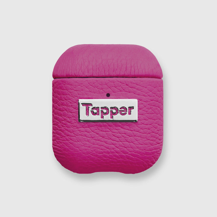 Tapper's luxurious hot pink genuine lamb leather AirPods case protects and elevates the look of your AirPods. The luxurious, protective case for AirPods with a metal logo plate colored in silver steps up your AirPods game. The next must-have high end protective Apple AirPods accessory in bright pink real leather and metal details. Compatible with AirPods (1st and 2nd generation). Designed in Sweden by Tapper. Free Express Shipping at gettapper.com
