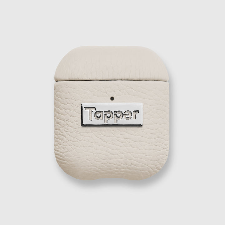 Tapper's luxurious sand beige genuine lamb leather AirPods case protects and elevates the look of your AirPods. The luxurious, protective case for AirPods with a metal logo plate colored in silver steps up your AirPods game. The next must-have high end protective Apple AirPods accessory in real leather and metal details. Compatible with AirPods (1st and 2nd generation). Designed in Sweden by Tapper. Free Express Shipping at gettapper.com