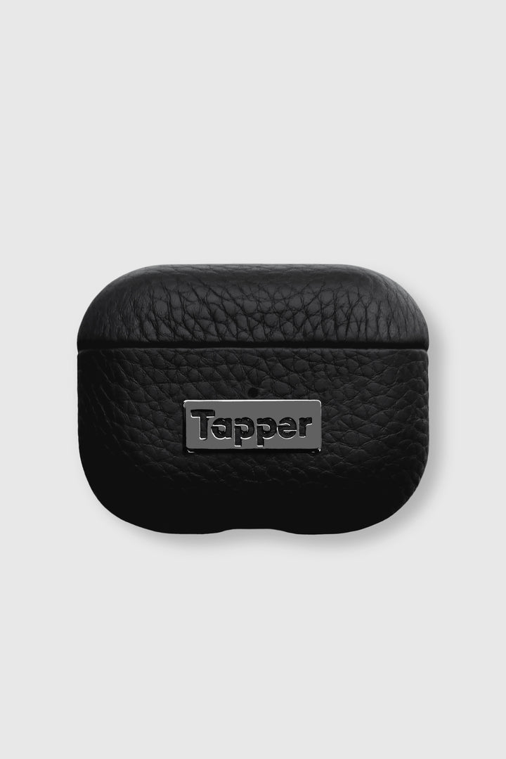 Tapper's luxurious black genuine lamb leather AirPods Pro case protects and elevates the look of your AirPods Pro. The luxurious, protective case for AirPods with a metal logo plate in hematite black plating steps up your AirPods game. The next must-have high end protective Apple AirPods accessory in real leather and precious metals. Compatible with AirPods Pro. Designed in Sweden by Tapper. Free Express Shipping at gettapper.com