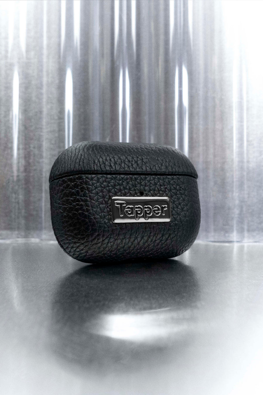Tapper's luxurious black genuine cow leather AirPods Pro case protects and elevates the look of your AirPods Pro. The luxurious, protective case for AirPods with a metal logo plate in hematite black plating steps up your AirPods game. The next must-have high end protective Apple AirPods accessory in real leather and precious metals. Compatible with AirPods Pro. Designed in Sweden by Tapper. Free Express Shipping at gettapper.com