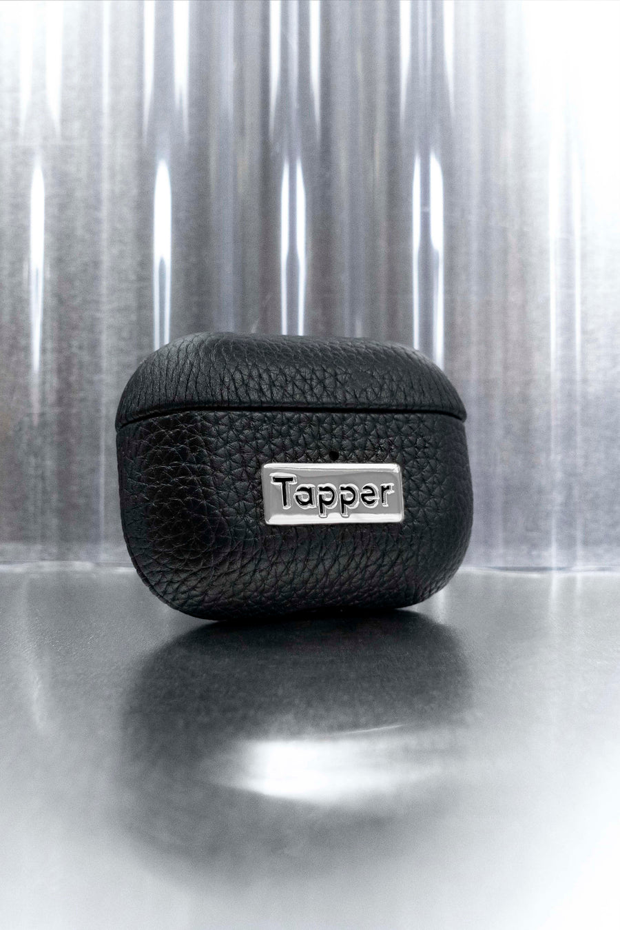 Tapper's luxurious black genuine cow leather AirPods case protects and elevates the look of your AirPods Pro. The luxurious, protective case for AirPods Pro with a metal logo plate colored in silver steps up your AirPods game. The next must-have high end protective Apple AirPods accessory in real leather and metal details. Compatible with AirPods Pro. Designed in Sweden by Tapper. Free Express Shipping at gettapper.com
