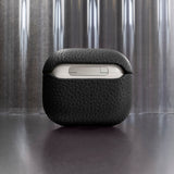Tapper's luxurious black genuine cow leather AirPods case protects and elevates the look of your AirPods. The luxurious, protective case for AirPods with a metal logo plate in real 18k gold plating steps up your AirPods game. The next must-have high end protective Apple AirPods accessory in real leather and precious metals. Compatible with AirPods (3rd generation). Designed in Sweden by Tapper. Free Express Shipping at gettapper.com