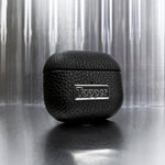 Tapper's luxurious black genuine cow leather AirPods case protects and elevates the look of your AirPods. The luxurious, protective case for AirPods with a metal logo plate in hematite black plating steps up your AirPods game. The next must-have high end protective Apple AirPods accessory in real leather and precious metals. Compatible with AirPods (3rd generation). Designed in Sweden by Tapper. Free Express Shipping at gettapper.com