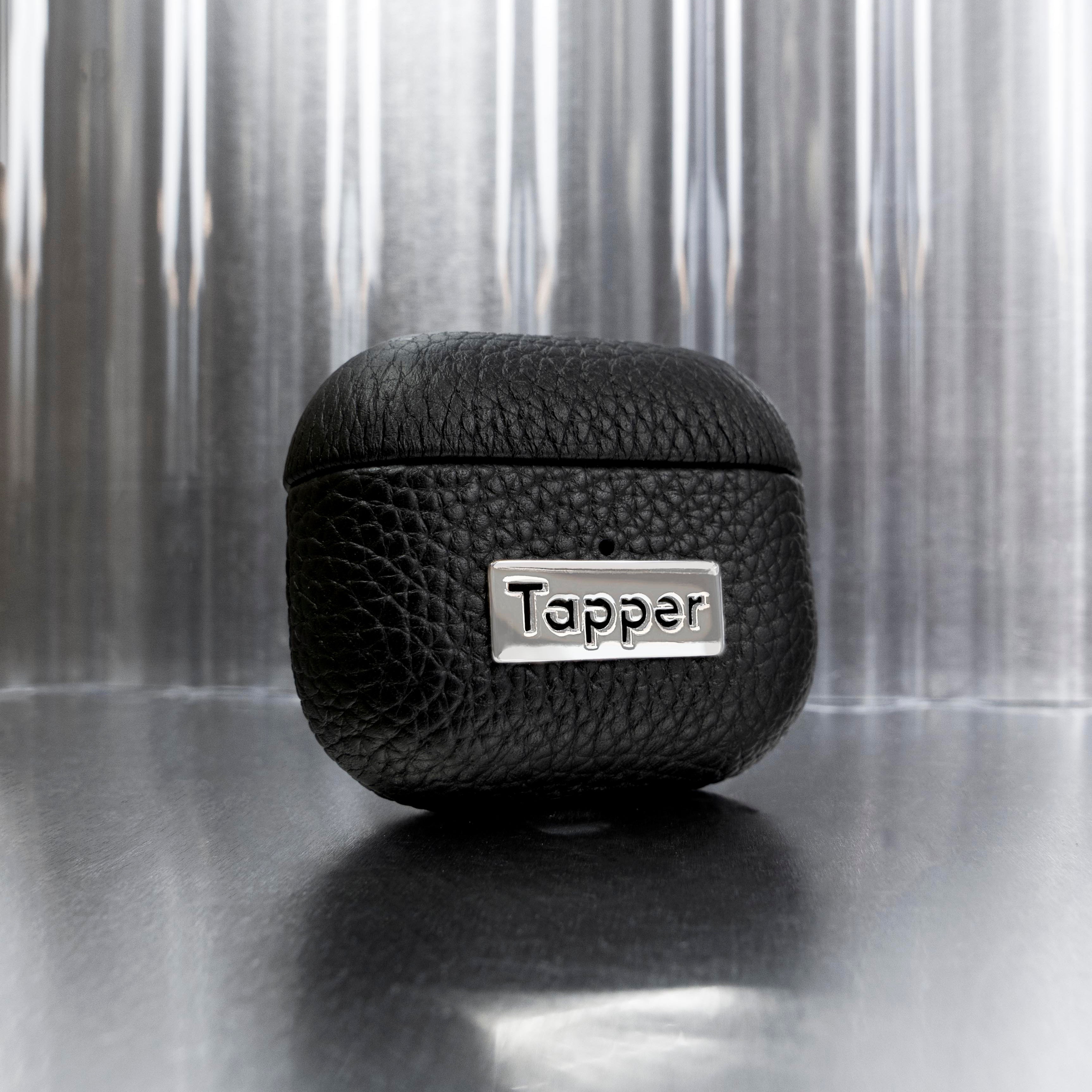 Tapper's luxurious black genuine cow leather AirPods case protects and elevates the look of your AirPods. The luxurious, protective case for AirPods with a metal logo plate colored in silver steps up your AirPods game. The next must-have high end protective Apple AirPods accessory in real leather with metal details. Compatible with AirPods (3rd generation). Designed in Sweden by Tapper. Free Express Shipping at gettapper.com
