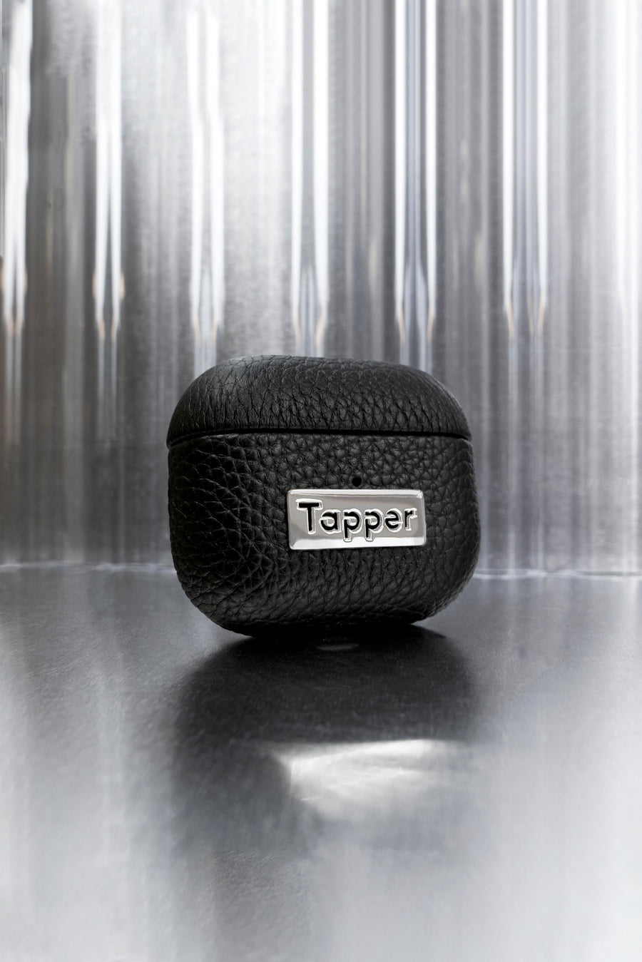 Tapper's luxurious black genuine cow leather AirPods case protects and elevates the look of your AirPods. The luxurious, protective case for AirPods with a metal logo plate colored in silver steps up your AirPods game. The next must-have high end protective Apple AirPods accessory in real leather with metal details. Compatible with AirPods (3rd generation). Designed in Sweden by Tapper. Free Express Shipping at gettapper.com