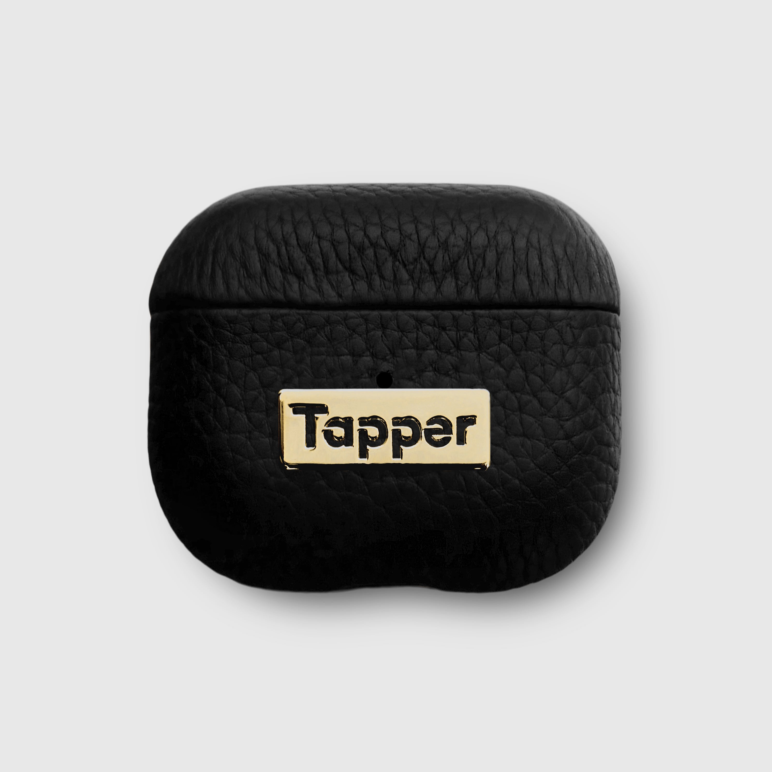 Tapper's luxurious black genuine lamb leather AirPods case protects and elevates the look of your AirPods. The luxurious, protective case for AirPods with a metal logo plate in real 18k gold plating steps up your AirPods game. The next must-have high end protective Apple AirPods accessory in real leather and precious metals. Compatible with AirPods (3rd generation). Designed in Sweden by Tapper. Free Express Shipping at gettapper.com