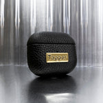 Tapper's luxurious black genuine cow leather AirPods case protects and elevates the look of your AirPods. The luxurious, protective case for AirPods with a metal logo plate in real 18k gold plating steps up your AirPods game. The next must-have high end protective Apple AirPods accessory in real leather and precious metals. Compatible with AirPods (3rd generation). Designed in Sweden by Tapper. Free Express Shipping at gettapper.com