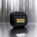 Tapper's luxurious black genuine cow leather AirPods case protects and elevates the look of your AirPods. The luxurious, protective case for AirPods with a metal logo plate in real 18k gold plating steps up your AirPods game. The next must-have high end protective Apple AirPods accessory in real leather and precious metals. Compatible with AirPods (3rd generation). Designed in Sweden by Tapper. Free Express Shipping at gettapper.com