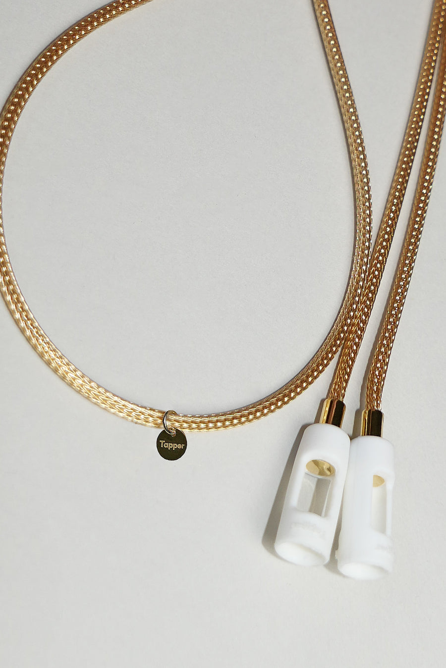 Tapper's solid 18K gold original mesh chain jewelry necklace protects your Apple AirPods & AirPods Pro. Handcrafted in real 18K gold, the exclusive, elevated & accessible mesh chain jewellery snaps the AirPods around your neck. Lost your AirPods? Magnetic lock for convenient and hassle-free safekeeping around your neck. The next must-have & luxe AirPods accessory crafted for ultimate luxury. Compatible with AirPods & AirPods Pro. Designed and handcrafted in Sweden by Tapper. Free Shipping at gettapper.com